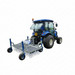 Rear-mounted view of the Campey UniRake attached to a blue tractor, designed for professional turf care. The UniRake features spring tines and support wheels, ideal for removing organic matter, thinning grass, and maintaining sports pitches, golf courses, and natural turf surfaces effectively.