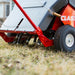 Close-up view of the Classen RA-21H reciprocating aerator tines penetrating the soil, showing durable wheels and spring mechanism for efficient lawn aeration.