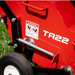 Close-up of a Classen TA22H aerator showing the warning label, wheel assembly, and part of the chassis, with a visible danger sign cautioning about rotating blades and instructing to keep hands and feet away