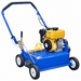 Crommelin 18" Bluebird Dethatcher shown from a front angle on a white background, featuring the EX17 engine, blue steel deck, operator handle, adjustment controls and four-wheel design.