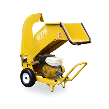 GTM Professional GTS1310RP yellow wood chipper with large feed chute, curved discharge chute, sturdy wheels, and white petrol engine, photographed from a left-front angle on a plain white background, designed for heavy-duty chipping of branches and garden debris.