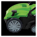 Close-up of the Draper Tools 2 in 1 Lawn Aerator/Scarifier showing the large grey front wheel, black tread, and green curved body panels, captured against a solid black background to highlight the wheel design and lower frame details.