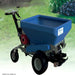 Angled outdoor view of the Eco 250 Top Dressing Spreader featuring its large blue hopper, red Honda engine, and durable pneumatic tires. Positioned on green grass, this machine is built for professional turf management, ensuring efficient and uniform topdressing applications.