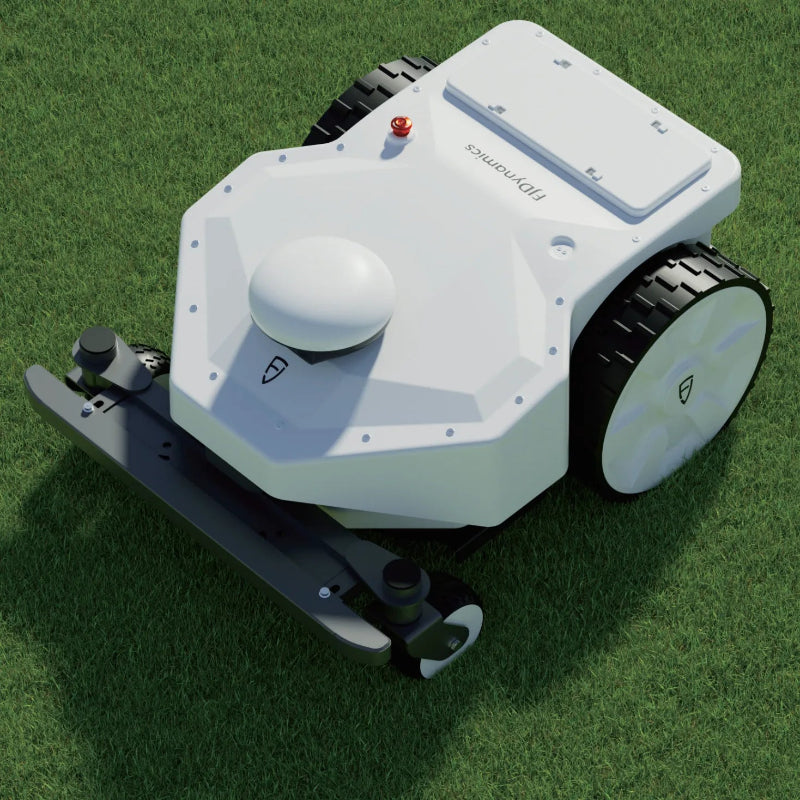 Top angled view of the FJD FRX Robotic Lawn Mower on grass, highlighting the RTK navigation dome, rugged all-terrain wheels, front bumper, and commercial autonomous mowing design.