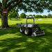 FJD RCM01 Robotic Lawn Mower operating beneath large trees on a golf course, demonstrating reliable RTK positioning and precise autonomous navigation while maintaining accurate mowing performance in partially obstructed environments.