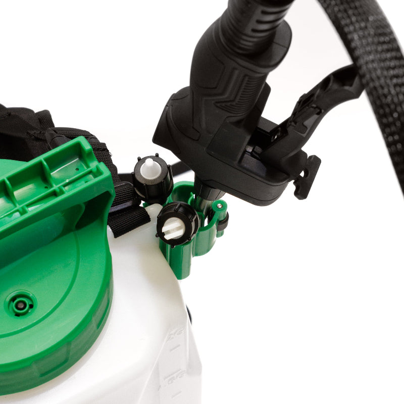 The image displays the back of a black and green backpack sprayer, featuring its padded shoulder straps and adjustable harness system designed for comfortable wear. The green elements visible are part of the sprayer's tank and components. 