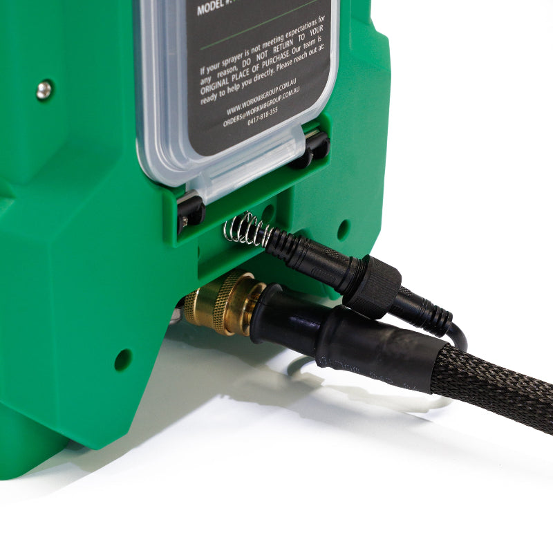 The image shows a close-up view of the connection ports and cables on a green FlowZone sprayer unit, likely a FlowZone Storm Handheld Sprayer with SwapTank or a FlowZone Typhoon 