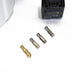 Close-up view of FlowZone MicroBurst 10L accessories displayed on a white surface, featuring one brass nozzle and three stainless steel nozzles neatly lined up. The edge of the battery pack and sprayer tank are partially visible in the frame.