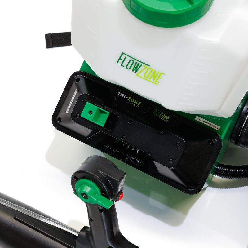 Close-up of FlowZone Vortex 10L backpack mister tank showing FlowZone branding, Tri-Zone technology battery compartment with green latch, and black control housing with visible control handle at the bottom, photographed on white background.
