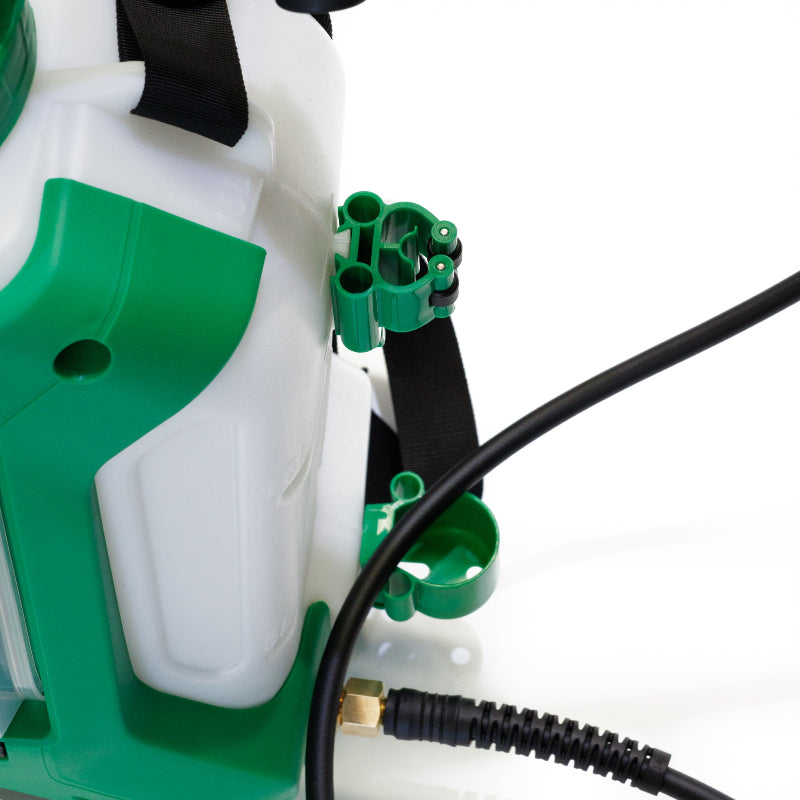 Close-up side view of FlowZone Zephyr 3 battery-powered sprayer highlighting the green nozzle storage clips and part of the white tank body. A black spray hose is connected at the bottom, showcasing accessory holders and build details of the backpack unit.