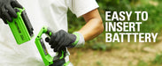 Close-up of a person inserting a Greenworks 40V lithium battery into the cordless hedge trimmer outdoors. The user wears gloves and a white shirt, with text reading “Easy to Insert Battery” on the right, emphasizing tool simplicity and ergonomic design.