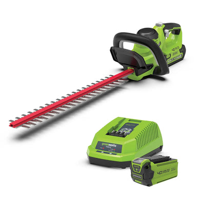 The Greenworks 40V Hedge Trimmer Kit features a cordless green and black trimmer with red dual-action blades, plus a matching 40V lithium battery and charger. Displayed on a clean white background highlighting its complete garden maintenance set.