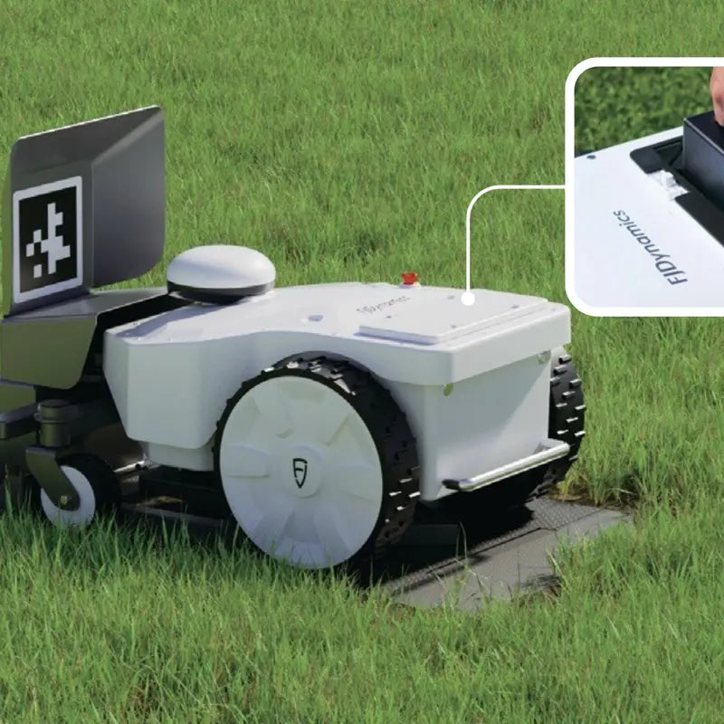 FJD FRX Robotic Lawn Mower automatically docking at its charging station, demonstrating autonomous recharging for continuous commercial lawn maintenance with minimal operator intervention