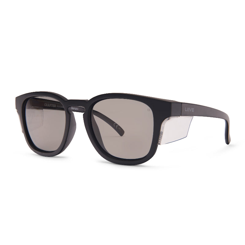 LIIVE Safety Crafter Polarised sunglasses in matte black with clear side blinkers. Features round-frame design, smoke lenses, and durable side protection—ideal for tradies and outdoor work safety.