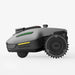 Side profile of the Mammotion Yuka Mini robotic lawn mower in gray, featuring rugged traction wheels, compact body design, and advanced side indicators, set against a plain white background.