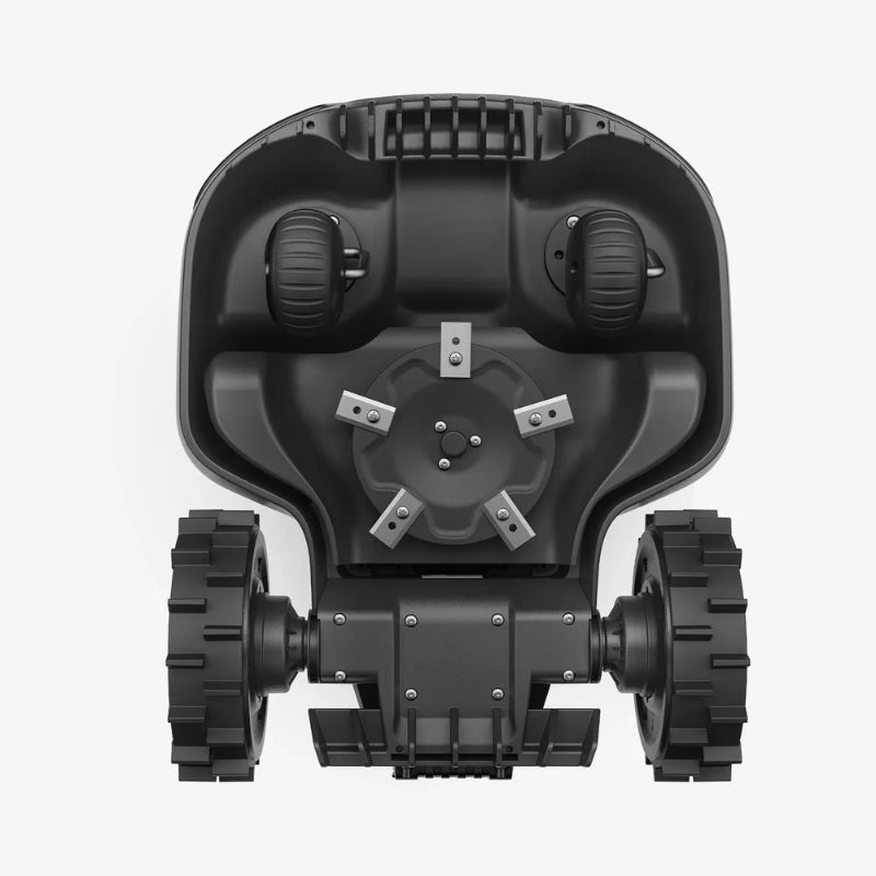 Underside view of the Mammotion Yuka Mini robotic lawn mower showing two front wheels, two large spiked rear wheels, and a central rotating cutting disk fitted with four sharp metal blades, displayed against a plain white background.
