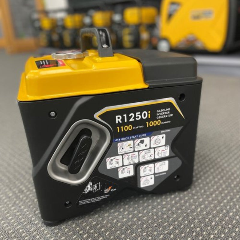 The image displays a RATO R1250i gasoline inverter generator, primarily black with a prominent yellow top and handle. The generator is compact and features a quick start guide diagram on its side panel, illustrating the steps for starting the unit. The label on the generator indicates its model number, R1250i, and highlights its "GASOLINE INVERTER GENERATOR" type, with "1100 STARTING" and "1000 RUNNING" specifications for its power output. 