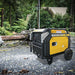 Rato R8000iE inverter generator in yellow and black positioned outdoors on a paved surface after a storm, with fallen power lines and trees in the background. Heavy-duty 7300W generator designed for reliable emergency backup and rugged performance.